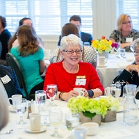 Alumni socializing at dinner table